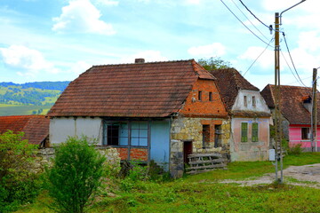 Fototapeta na wymiar Typical rural landscape and peasant houses in Drauseni, Transylvania,Romania. The settlement was founded by the Saxon colonists in the middle of the 12th century