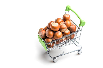 Miniature cart from the supermarket. A cart full of nuts. A lot of Hazelnuts isolated on a white background.