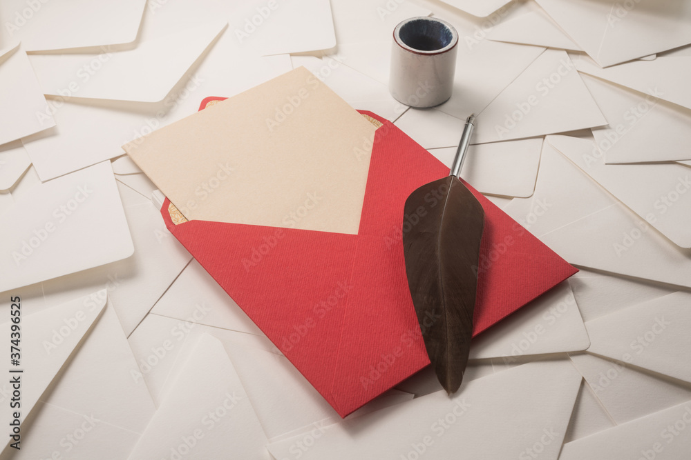 Wall mural Red Envelope, goose feather, inkwell on a wood table  