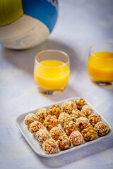 energy protein balls made with dry apricots, raisins, dates, walnuts, sunflower seeds, pumpkin seeds, sesame
