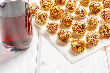 energy protein balls made with dry apricots, raisins, dates, walnuts, sunflower seeds, pumpkin seeds, sesame