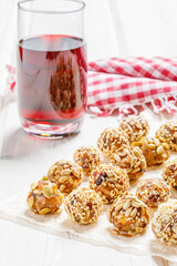 energy protein balls made with dry apricots, raisins, dates, walnuts, sunflower seeds, pumpkin seeds, sesame