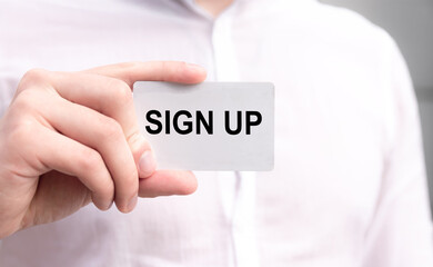 Businessman in white shirt holding a white card with the word 