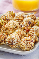 energy protein balls made with dry apricots, raisins, dates, walnuts, sunflower seeds, pumpkin seeds, sesame