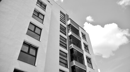 Detail of modern residential flat apartment building exterior. Fragment of new luxury house and home complex. Black and white.