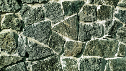 Gray stone wall. Stone masonry