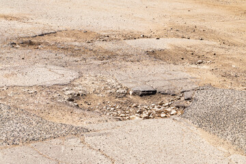 Road wet from rain and snow that needs maintenance. Dangerous road, road closed, destroyed canvas