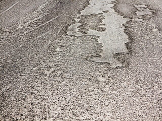 Road wet from rain and snow that needs maintenance. Dangerous road, road closed, destroyed canvas