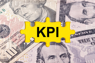 Puzzle with the image of dollars in the center of the inscription -KPI