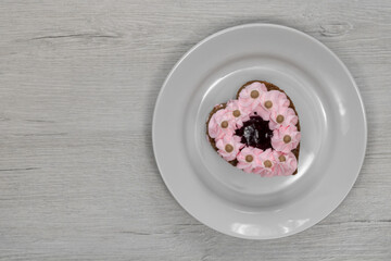 Heart-shaped cake. Cake on a white saucer.