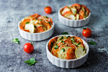 Zucchini tomato casserole with pepper and parsley in white bowl