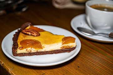 Curd pie with apricots and a Cup of black coffee for breakfast. Selective focus.