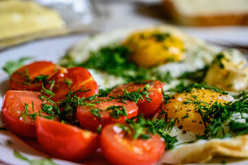 Scrambled eggs with cherry tomatoes for breakfast. Selective focus.