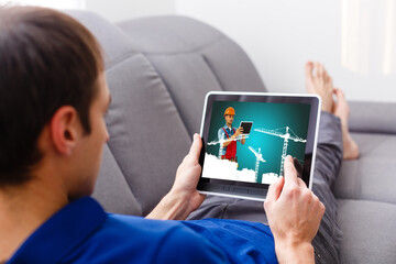 worker on tablet screen. Concept of online monitoring of the repairs