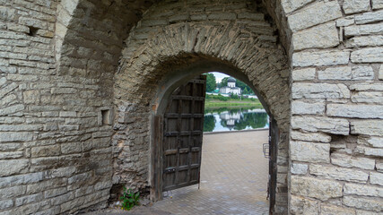 Fototapeta na wymiar Pskov, Russia. Gate to the complex of fortifications on the banks of the Velikaya River