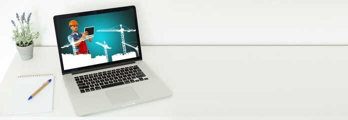 young manual worker displaying laptop over white background