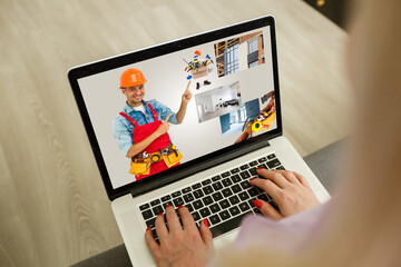 young manual worker displaying laptop over white background