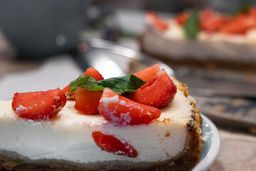 Slice of cheesecake with strawberries and mint. Selective focus, close-up