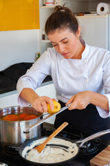 young woman cooking in kitchen