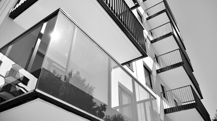 Detail of modern residential flat apartment building exterior. Fragment of new luxury house and home complex. Black and white.