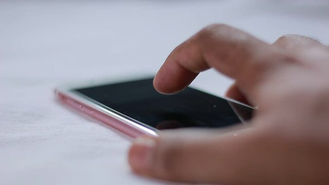 Close up of someone operating a smartphone using touchscreen gestures
