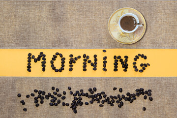 A cup of coffee on a natural napkin and the inscription 