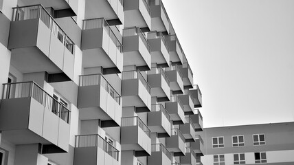 Detail of modern residential flat apartment building exterior. Fragment of new luxury house and home complex. Black and white.