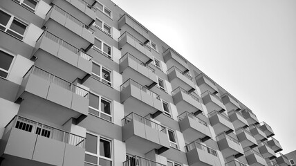 Detail of modern residential flat apartment building exterior. Fragment of new luxury house and home complex. Black and white.