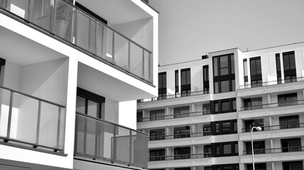 Detail of modern residential flat apartment building exterior. Fragment of new luxury house and home complex. Black and white.