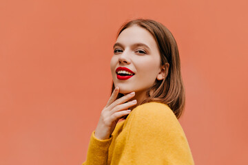 Curious woman in yellow outfit chilling in studio. Indoor shot of adorable caucasian girl with short hairstyle looking to camera with smile. - Powered by Adobe