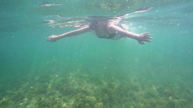 A beautiful girl snorkeling in the mediterranean sea.