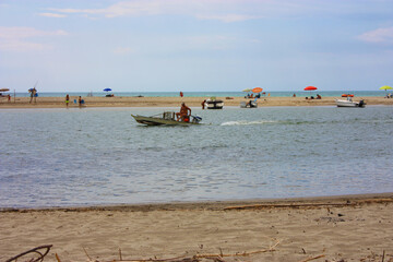 glimpse of sea and river among the nature of marina di pisa in the tuscan serenity of the summer landscape