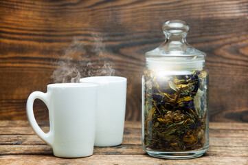 Two cups. Herbal aromatic tea. On a wooden table