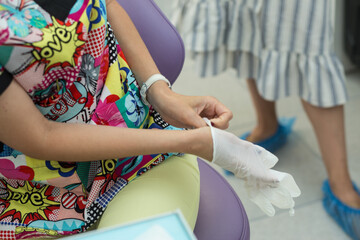 Girl medical worker puts on gloves