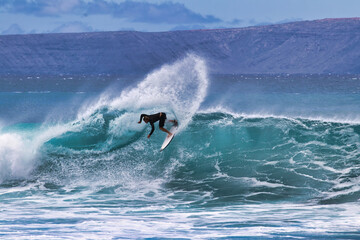 High energy ,unrecognizable sufer on Maui.