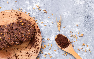 Stack of tasty cocoa cookies with wheat and peanut on rustic table, handmade or prepared snack food