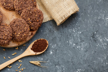 Stack of tasty cocoa cookies with wheat and peanut on rustic table, handmade or prepared snack food