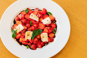 Strawberry Brioche Carpaccio. Fresh summer fruit dessert with strawberries and cheese. Close up view.
