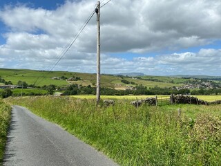 Fototapeta na wymiar Roadside view, with long grasses, fields, hills and farms near, Trawden, Colne, UK