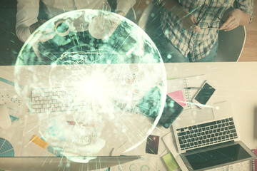 Double exposure of man and woman working together and business theme hologram drawing. Computer background. Top View.