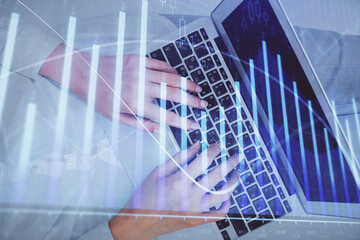 Double exposure of woman hands working on computer and forex chart hologram drawing. Top View. Financial analysis concept.