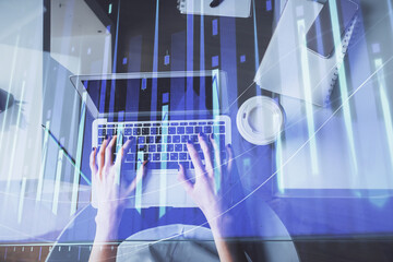 Double exposure of woman hands working on computer and forex chart hologram drawing. Top View. Financial analysis concept.