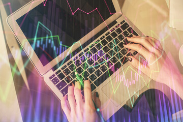 Double exposure of woman hands working on computer and forex chart hologram drawing. Top View. Financial analysis concept.
