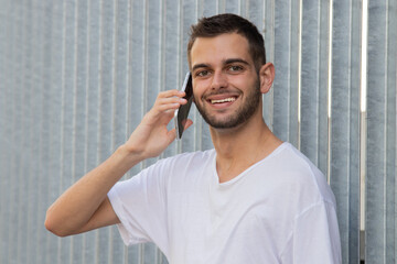 attractive young man with mobile phone on the street