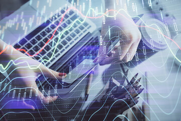 Double exposure of businesswoman hands typing on computer and financial graph hologram drawing. Stock market analysis concept.