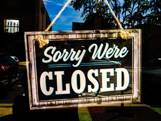 Sorry We're Closed Sign Hanging On Store Window
