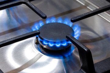 Gas Concepts. Closeup Macro Shoot of Gas Burner on Stove Surface with Fire Flames.