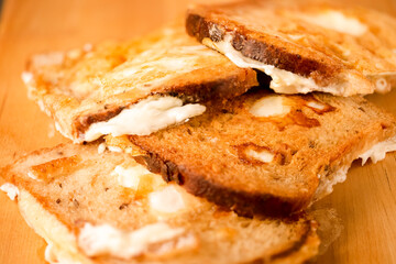 Large Number of Tasty Slices of Traditional Fried Bread With Fried Eggs Together. Over Wooden Board Indoors.