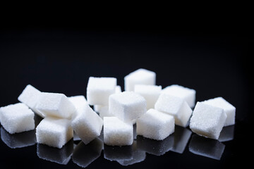 Closeup Macro Shoot of White Cube Sugar Placed Bulk Against Black Background.