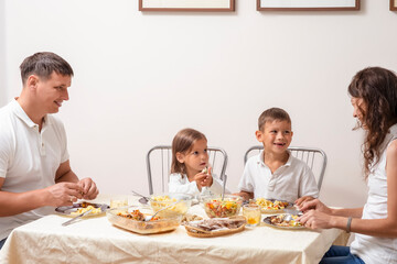 Family Concepts. Parents with Their Children Having Breakfast at Home Together.